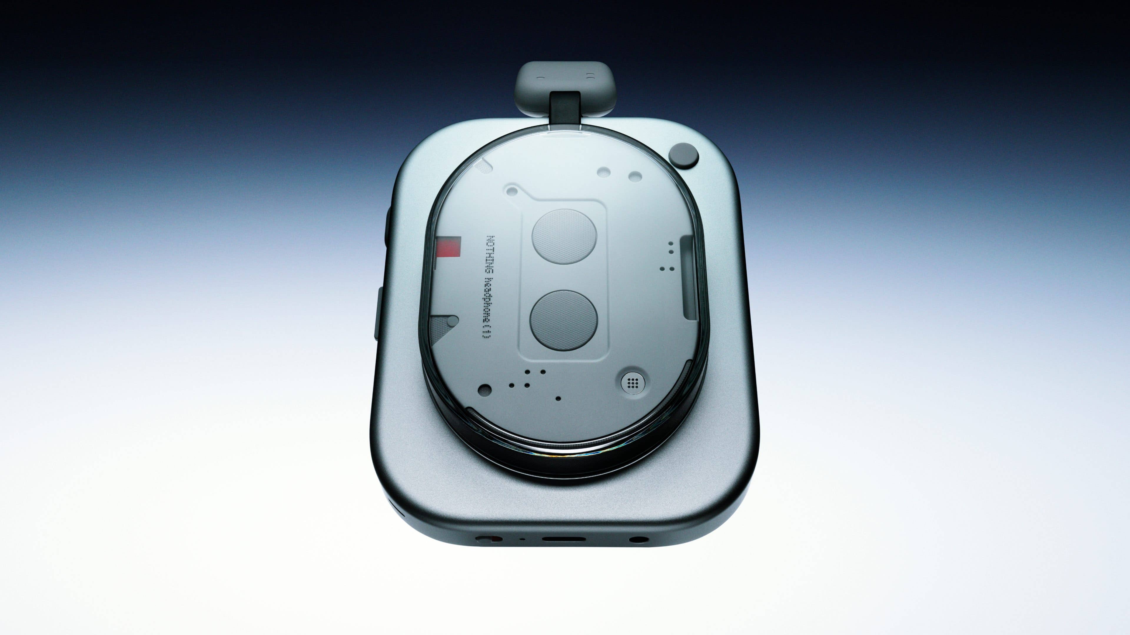 A top view of the Nothing headphone, featuring a sleek design with buttons and a transparent surface.
