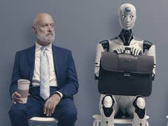 Person and Roboter sitting on chairs