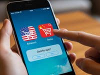 A hand holding an iPhone displaying Amazon and Temu app icons with a delete confirmation message.