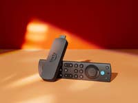 Amazon Fire TV Stick 4K Max and remote control on a colorful background.