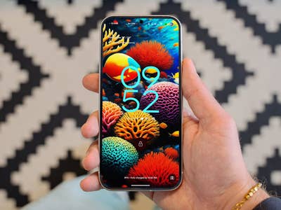 Google releases the Android 16 QPR2 Beta 3 update with tons of fixes. A hand holding a Google Pixel 9 smartphone displaying a colorful coral-themed wallpaper and the time 09:52.