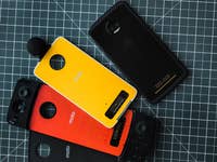 Motorola Moto Z phone (right), next to a series a modules: 360 camera, gamepad and battery.
