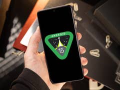 A person holding a phone with the Android 15 preview logo highlighted in the display
