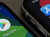 Two smartphones displaying the App Store and Google Play Store logos.