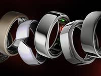 Seven diverse smart rings displayed in a row, aligned side by side.