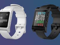 Two smartwatches side by side, one white with a black screen, the other black with a colorful display.