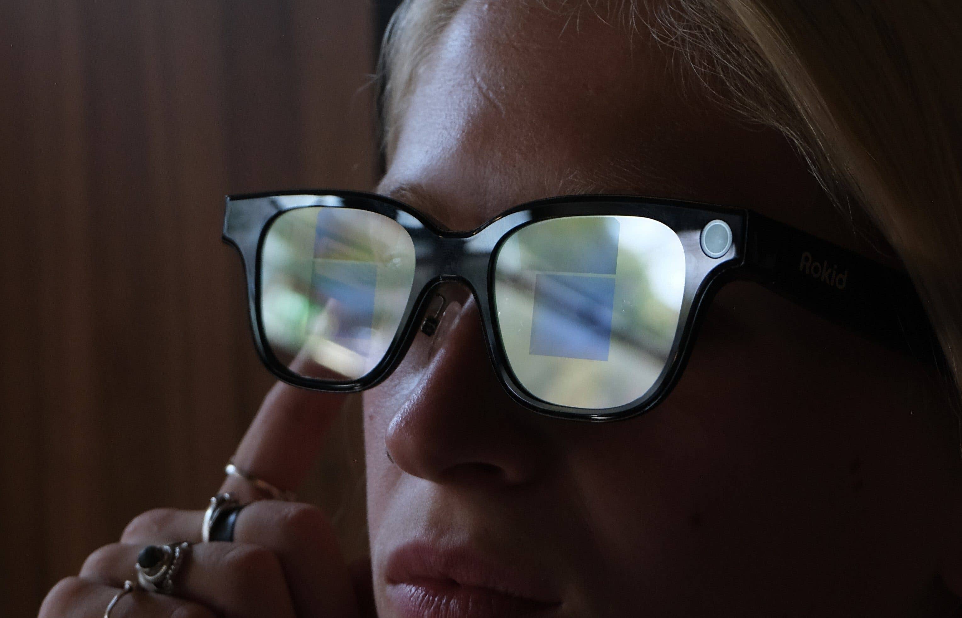 Close-up of Rokid smart glasses reflecting a digital display.