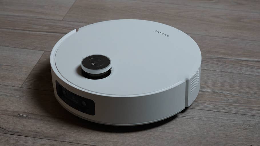 The Dreame Aqua10 Ultra Track robot vacuum cleaner on a wooden floor.
