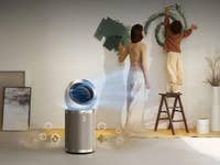 A woman and child painting a wall, with a Dreame AirPursue PM20 air purifier in the foreground.