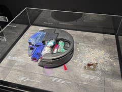 Display of the Dyson Spot+Scrub Ai, showcasing its internal components and cleaning capabilities.