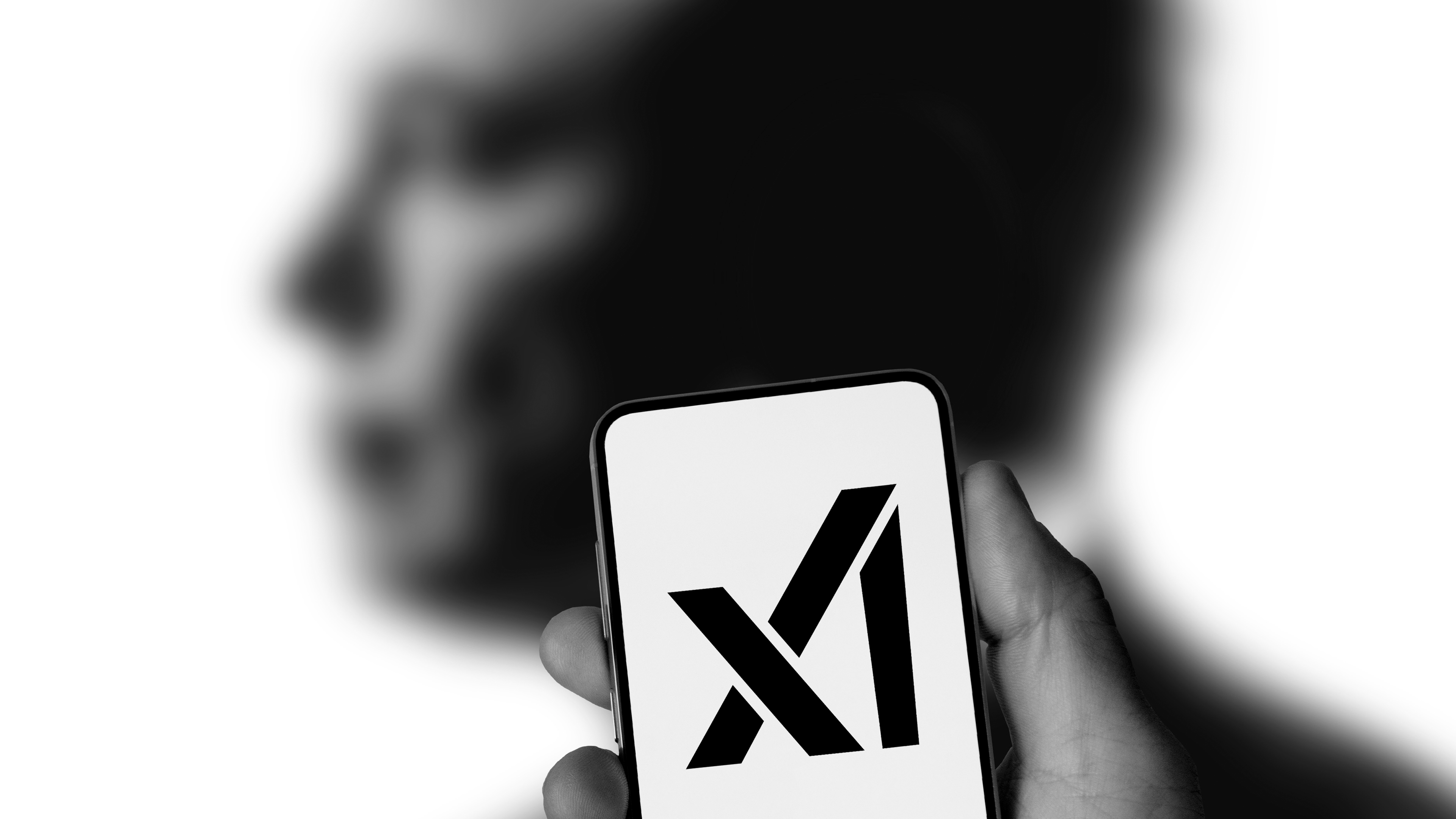 A hand holding a smartphone displaying the 'X' logo against a blurred human silhouette. A hand holding a smartphone displaying the 'X' logo against a blurred human silhouette.