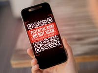 A smartphone displaying a warning QR code with text: 'POTENTIAL RISK! DO NOT SCAN!'