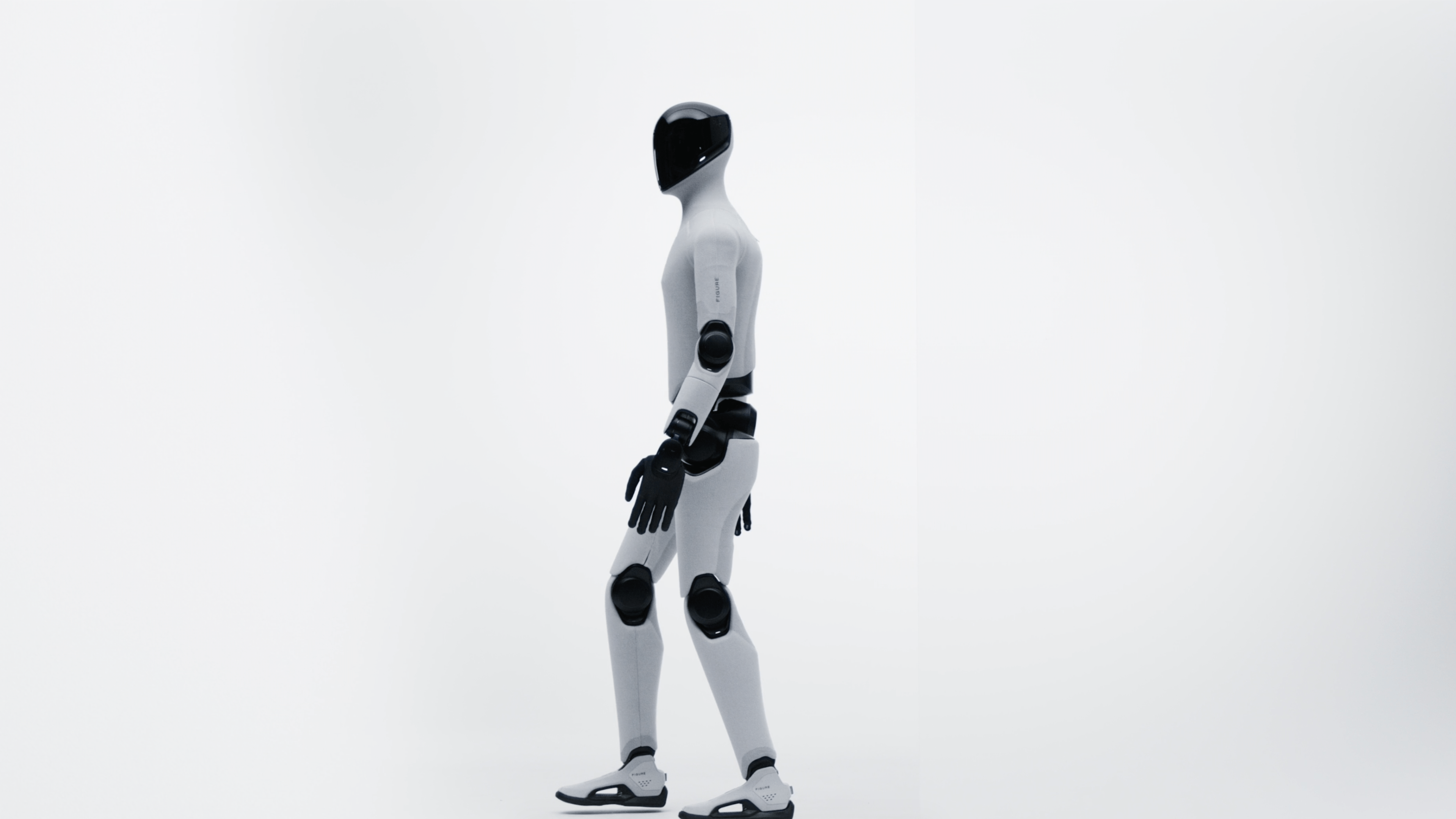 A humanoid robot with a sleek design walking on a white background.