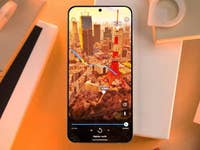 A smartphone displaying a Google Maps route over a cityscape.