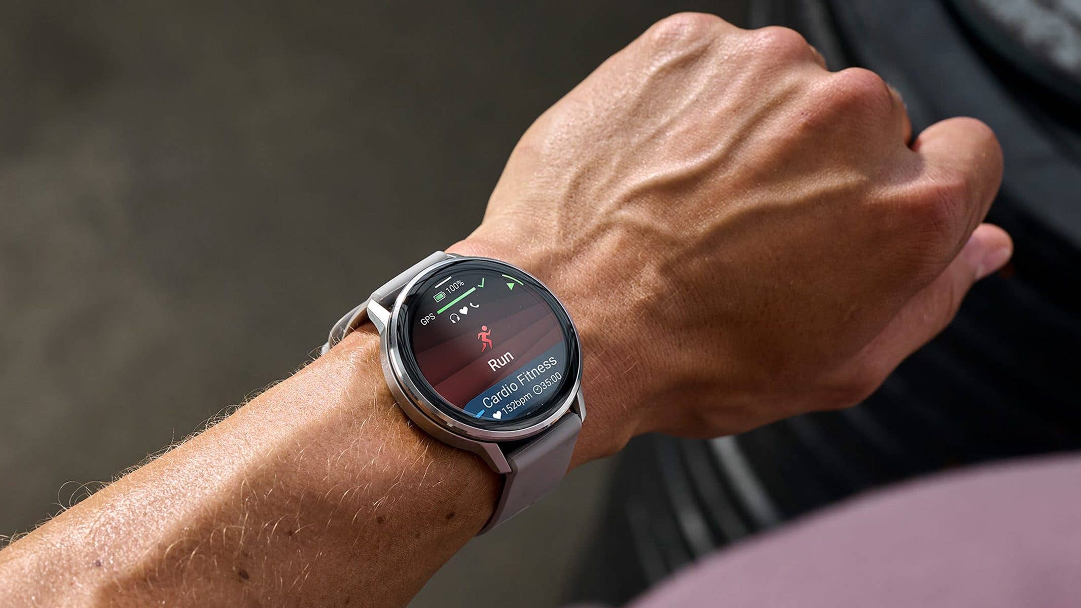 A Garmin Venu 4 smartwatch displaying running stats on a person's wrist.