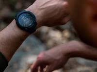 A close-up of a Garmin Instinct 3 Tactical Edition watch on a wrist, displaying a digital screen with the reading 2933.