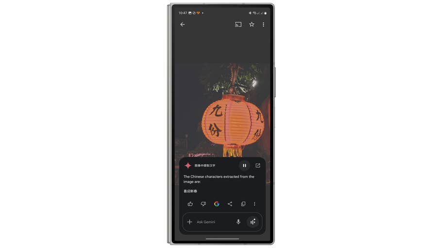 A glowing orange lantern with Chinese characters hanging in the dark.