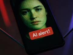 A smartphone displaying a face with a green grid overlay and an 'AI alert!' message.