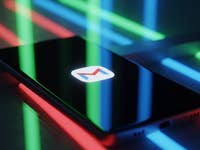 A smartphone displaying the Gmail logo, surrounded by colorful neon lights.