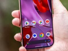 A person holding a Google Pixel 9 smartphone displaying app icons on the screen.