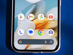 Close-up of a smartphone home screen displaying Google apps and icons.