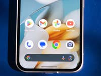 Close-up of a smartphone home screen displaying Google apps and icons.