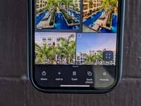 A smartphone screen displaying a Google Photos interface with four images of a pool area and palm trees.
