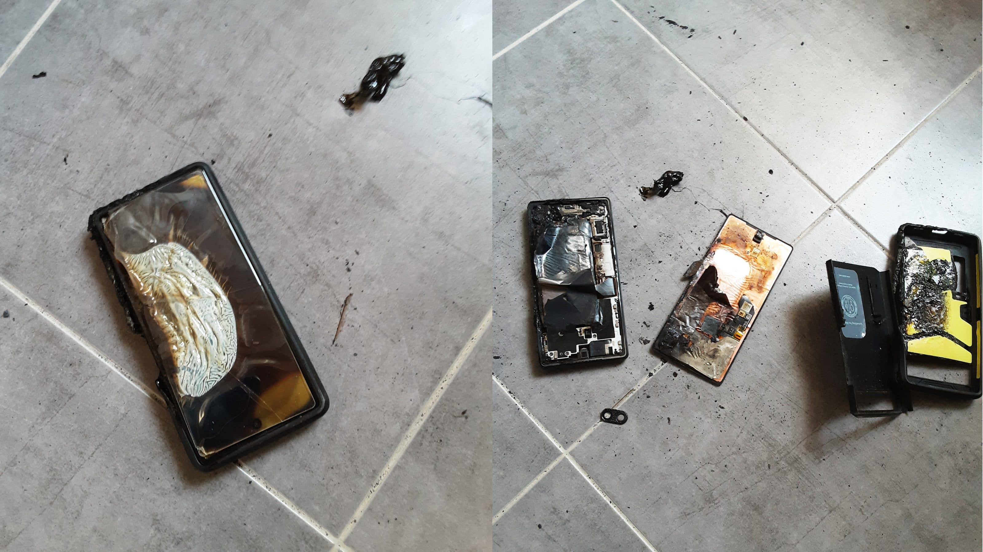 Damaged Google Pixel 6a smartphone with visible burn marks on a tiled floor.