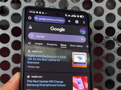 A smartphone displaying the Google search page with 'nextpit' query and news articles below.