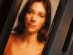 A blurred photo of a woman displayed on a smartphone screen.