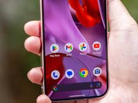 A hand holding a Google Pixel 9 Pro smartphone displaying various app icons.