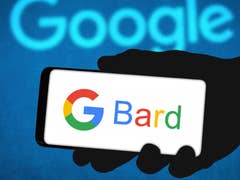 A hand holding a phone with "G Bard" words highlighted in it.