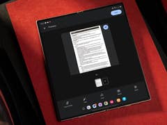 A tablet displaying a document preview on a red background.