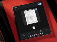 A tablet displaying a document preview on a red background.