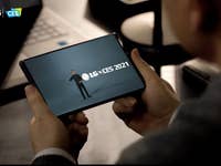 A person holding a smartphone displaying LG CES 2021.