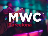 The MWC logo highlighted in an image with a person using a tablet in the background