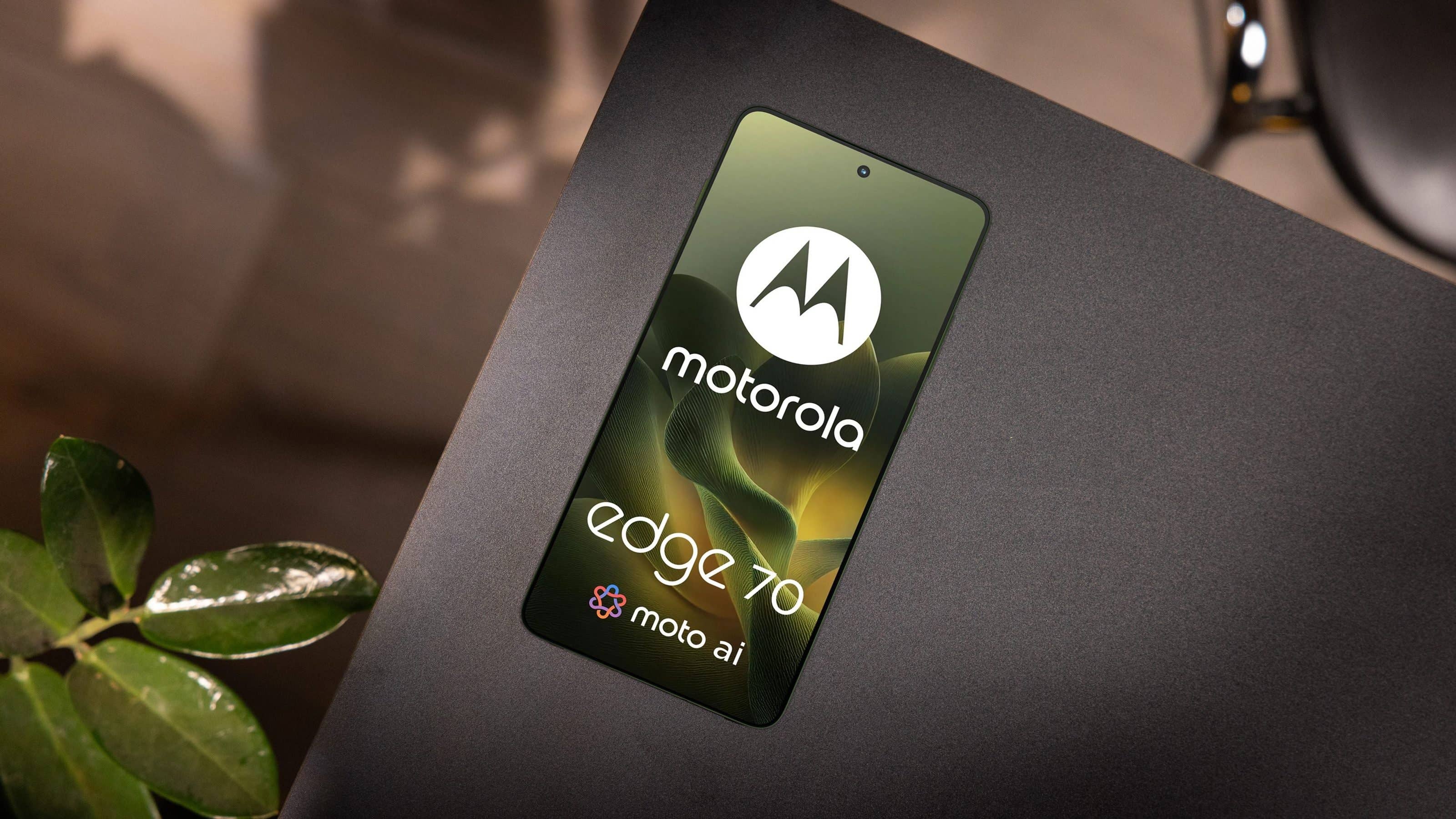 A Motorola Edge 70 smartphone laying on a black surface, showcasing its logo and screen design.