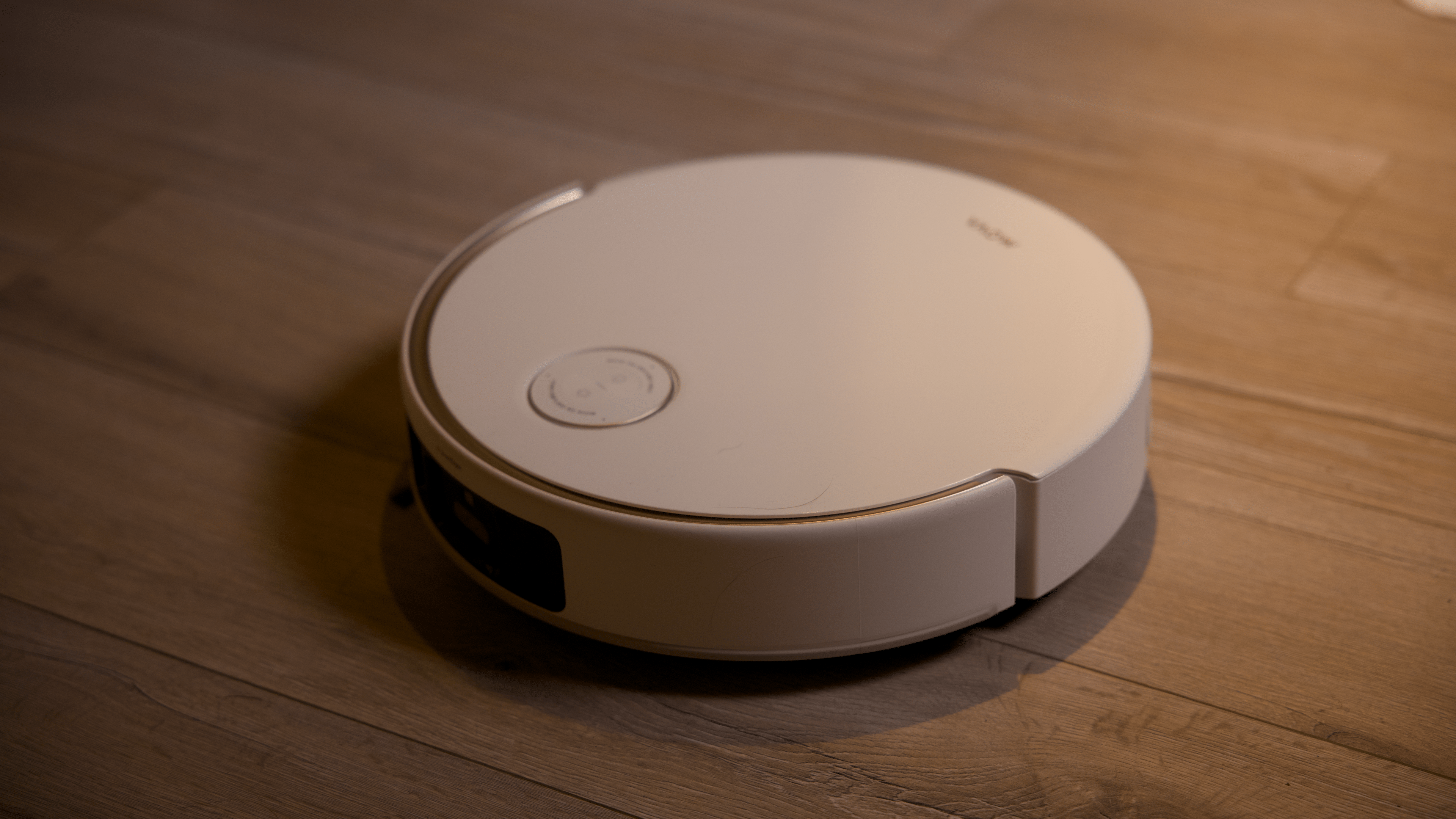 A Mova V50 Ultra Complete robotic vacuum cleaner on a wooden floor.
