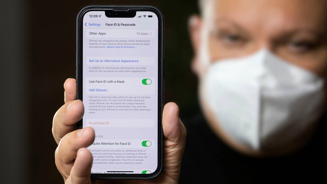 A person showing the Face ID settings on an iPhone display A person showing the Face ID settings on an iPhone display