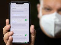 A person showing the Face ID settings on an iPhone display