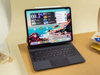 iPad with keyboard on a table surround by desk supplies.