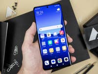 The Xiaomi 13 Pro held in a left hand and seen from the front with its AMOLED screen
