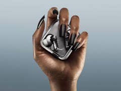 A hand holding the Nothing Ear 3 earbuds in their case, showcasing sleek design.