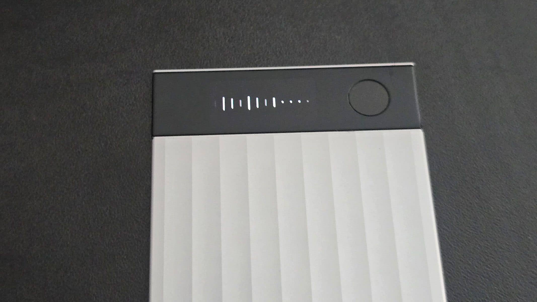 Top view of a Plaud Note Pro device displaying battery indicators and a power button. Top view of a Plaud Note Pro device displaying battery indicators and a power button.