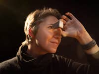 A person holding a view master and looking inside of it