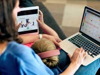 Children using a tablet under an adult supervision