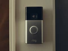 A Ring video doorbell mounted on a wall.