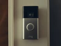 A Ring video doorbell mounted on a wall.