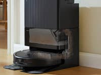 Roborock robotic vacuum cleaner with a docking station, designed for automatic cleaning and dirt disposal.