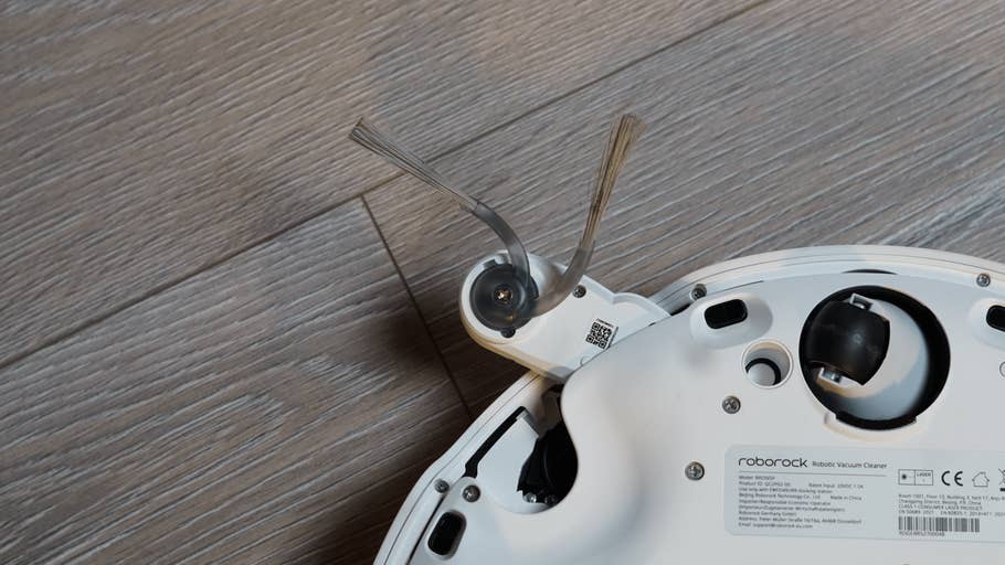 A close-up of the Roborock Qrevo Curv 2 Pro robot vacuum cleaner with its side brush.